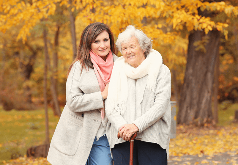Family caregivers like this woman taking a walk with an elderly woman can handle health information management for their loved ones with the RK360 App.